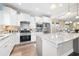 Bright kitchen features white cabinets, stainless steel appliances, and marble countertops at 402 Switchgrass Dr, Summerville, SC 29486