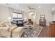 Cozy living room with stylish furnishings, including a blue sofa, patterned rug, and natural light, perfect for relaxation at 402 Switchgrass Dr, Summerville, SC 29486