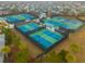 Overhead shot of the tennis courts, showcasing the green and blue surfaces, surrounding trees, and a glimpse of nearby homes at 402 Switchgrass Dr, Summerville, SC 29486