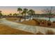 Manicured walking path with lake view and palm trees throughout the community at 402 Switchgrass Dr, Summerville, SC 29486