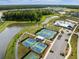 Aerial view of a modern community offering tennis courts, basketball court, and a pond at 46 Clearblue Loop, Summerville, SC 29486