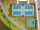 Aerial view of pickleball and basketball courts in a modern community with walking trails at 46 Clearblue Loop, Summerville, SC 29486