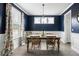 Elegant dining room featuring a large wooden table, floral curtains, and rich, dark blue walls at 46 Clearblue Loop, Summerville, SC 29486