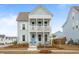 Charming two-story home with double porches, a blue front door, and meticulously landscaped yard at 46 Clearblue Loop, Summerville, SC 29486