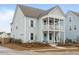 A charming two-story home with a double porch in a neighborhood of homes, and a landscaped yard at 46 Clearblue Loop, Summerville, SC 29486