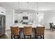 Bright kitchen boasts an island with seating, white cabinets, and stainless steel appliances at 46 Clearblue Loop, Summerville, SC 29486