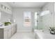 This is a spacious bathroom with marble tiling, double sinks, a bathtub, and a glass shower at 46 Clearblue Loop, Summerville, SC 29486