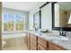 Bathroom showcasing dual sinks, granite countertops, and natural light at 4993 Lake Palmetto, North Charleston, SC 29418