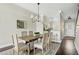 Dining area with hardwood floors, a modern chandelier, and a view into the kitchen at 4993 Lake Palmetto, North Charleston, SC 29418