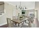 Open dining area with wood table, stylish lighting, and serene views to the outdoors at 4993 Lake Palmetto, North Charleston, SC 29418