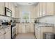 Bright kitchen features white cabinets, granite countertops, stainless steel appliances, and a window at 4993 Lake Palmetto, North Charleston, SC 29418