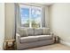 Cozy sitting area with a comfortable couch near a bright window with blinds at 4993 Lake Palmetto, North Charleston, SC 29418