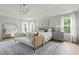 Bright primary bedroom with a stylish rug, bench, and decorative wall paneling at 500 Eagleview Dr, Moncks Corner, SC 29461