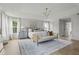 Elegant primary bedroom with tray ceiling, patterned rug, and abundant natural light at 500 Eagleview Dr, Moncks Corner, SC 29461