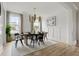 Elegant dining room with hardwood floors, modern light fixture, neutral colors and views of the outdoors at 500 Eagleview Dr, Moncks Corner, SC 29461