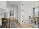 Bright hallway featuring hardwood floors, stylish lighting, and a view into a home office and backyard at 500 Eagleview Dr, Moncks Corner, SC 29461