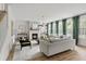 Bright living room with a fireplace, modern furniture, and large windows with green curtains at 500 Eagleview Dr, Moncks Corner, SC 29461