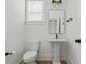 Modern powder room featuring a pedestal sink, modern fixtures and a sleek minimalist design at 500 Eagleview Dr, Moncks Corner, SC 29461