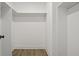 Empty walk-in closet with wood flooring and white shelving at 500 Eagleview Dr, Moncks Corner, SC 29461