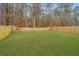 A fenced backyard features a large grassy lawn and perimeter trees at 500 Minim St, Charleston, SC 29414