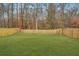 A fenced backyard features a large grassy lawn with perimeter trees at 500 Minim St, Charleston, SC 29414