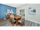 Bright dining room with wood table, view to outdoor patio, modern buffet and elegant artwork at 500 Minim St, Charleston, SC 29414