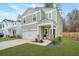 Charming two-story home featuring a white garage door and an inviting, covered front porch at 500 Minim St, Charleston, SC 29414