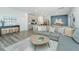 Stylish living room featuring a comfortable gray sofa, wood floors, and an open layout to kitchen at 500 Minim St, Charleston, SC 29414