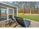 Relaxing screened porch with lounge chairs overlooking the expansive, fenced backyard at 500 Minim St, Charleston, SC 29414