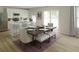 Bright kitchen with stainless steel appliances, white cabinets, and a spacious dining area at 5032 Scow Ct, Summerville, SC 29485