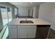 Kitchen island with stainless steel sink and white cabinets at 5032 Scow Ct, Summerville, SC 29485
