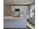 Bright kitchen featuring white cabinets, an island with a sink, and modern appliances at 5032 Scow Ct, Summerville, SC 29485