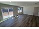 Spacious living room featuring wood-look floors and sliding glass doors to the backyard at 5032 Scow Ct, Summerville, SC 29485