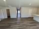 Spacious living room featuring modern gray flooring and ample natural light streaming through the hallway at 5032 Scow Ct, Summerville, SC 29485