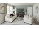 Bright living room with large windows, modern furniture, neutral color palette and decorative accents at 5032 Scow Ct, Summerville, SC 29485