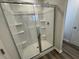 Beautiful glass shower with a sleek shower-head, a white interior and convenient shelving at 5032 Scow Ct, Summerville, SC 29485