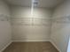 Spacious walk-in closet with organized shelving and neutral carpet at 5032 Scow Ct, Summerville, SC 29485