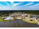 Aerial view showcasing the community amenities, including pool, clubhouse, tennis courts, and lake at 550 Tidewater Chase Ln, Summerville, SC 29486