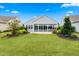 Spacious backyard featuring lush lawn and well-maintained landscaping and sunroom at 550 Tidewater Chase Ln, Summerville, SC 29486