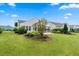 Well-maintained backyard with green grass, garden beds and view of the screened-in porch at 550 Tidewater Chase Ln, Summerville, SC 29486