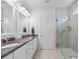 Bright bathroom featuring a double vanity with granite countertop and glass-enclosed shower at 550 Tidewater Chase Ln, Summerville, SC 29486
