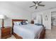 Cozy bedroom featuring a wooden bed frame, ceiling fan, and stylish decor at 550 Tidewater Chase Ln, Summerville, SC 29486