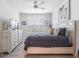 This bedroom features a dresser, ceiling fan, shuttered windows and wood flooring at 550 Tidewater Chase Ln, Summerville, SC 29486