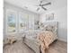 Bright bedroom with light wood flooring, plantation shutters, and ceiling fan at 550 Tidewater Chase Ln, Summerville, SC 29486