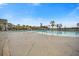 A large community pool is surrounded by palm trees, lounge chairs, and well-manicured landscaping at 550 Tidewater Chase Ln, Summerville, SC 29486