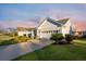 Well-maintained home boasts mature landscaping and a neatly paved driveway at 550 Tidewater Chase Ln, Summerville, SC 29486