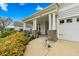 Inviting front porch with brick supports, garden and bench seating at 550 Tidewater Chase Ln, Summerville, SC 29486