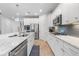 Bright kitchen with stainless steel appliances, white cabinets, and a large center island with marble countertops at 550 Tidewater Chase Ln, Summerville, SC 29486