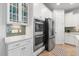 Kitchen features stainless steel appliances, white cabinets and granite countertops at 550 Tidewater Chase Ln, Summerville, SC 29486