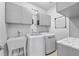 Functional laundry room with new washer and dryer, sink, cabinets, and hanging rack at 550 Tidewater Chase Ln, Summerville, SC 29486